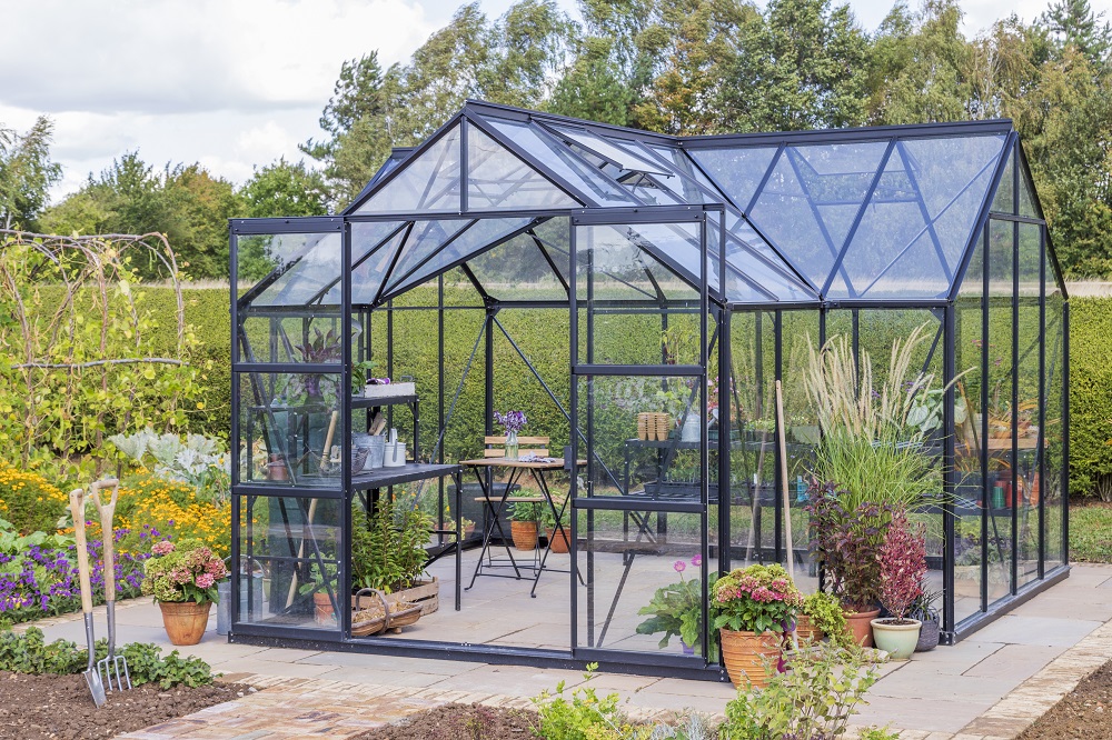 Large greenhouse with double sliding doors in vegetable garden