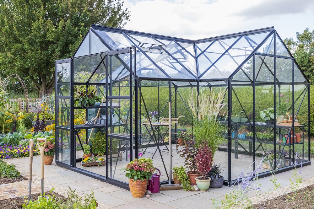 Large greenhouse with double sliding doors in vegetable garden